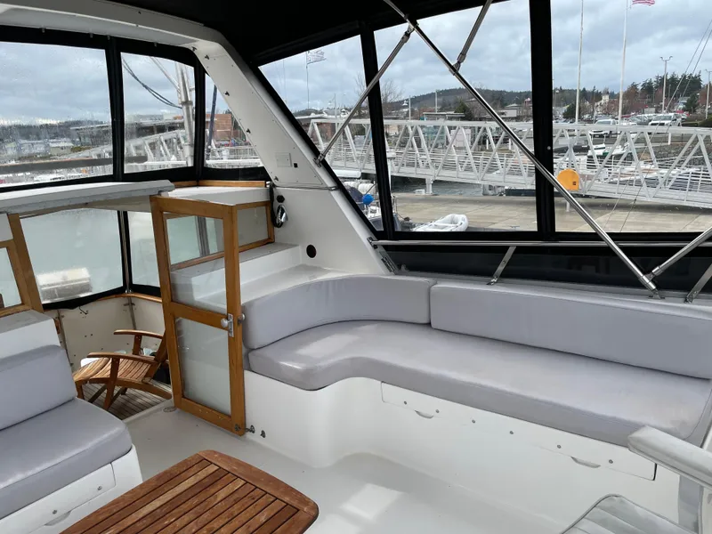 Slide: The Image of 1987 Lien Hwa 47' Mark III Sundeck Aft Cabin Motor Yacht interior with seating and marina view. - 14