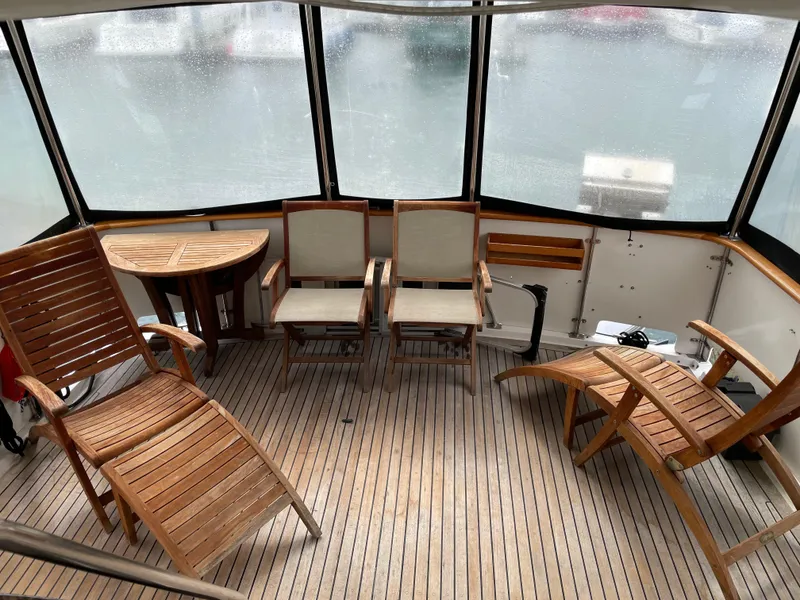 Slide: The Image of 1987 Lien Hwa 47' Mark III yacht sundeck with wooden chairs and table. - 15