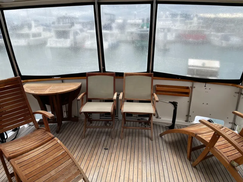 Slide: The Image of Aft cabin of 1987 Lien Hwa 47' Mark III yacht with wooden chairs and table. - 16