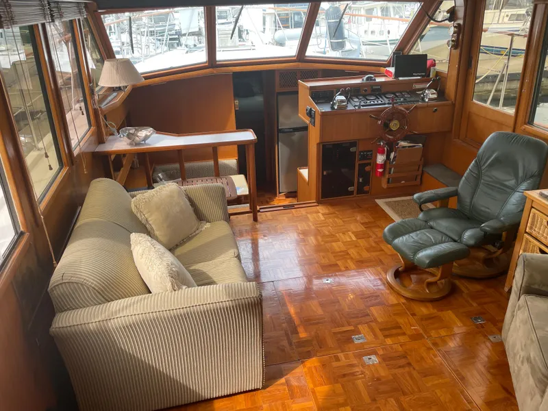 Slide: The Image of 1987 Lien Hwa 47' Mark III yacht interior with sofa, chair, and helm station. - 19