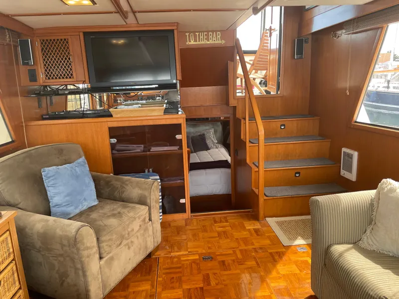 Slide: The Image of Interior of 1987 Lien Hwa 47' Mark III Sundeck Yacht with cozy seating and TV. - 22