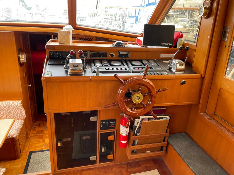 Slide: The Image of 1987 Lien Hwa 47' Mark III yacht helm with wooden wheel and navigation controls. - 24