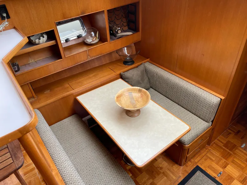 Slide: The Image of 1987 Lien Hwa 47' yacht interior with cozy dining area and wooden cabinetry. - 26