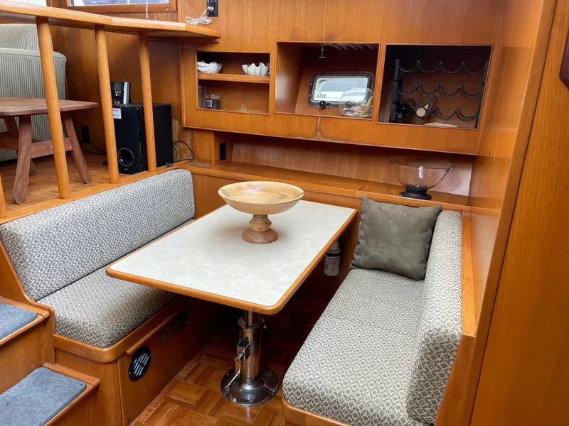 Slide: The Image of 1987 Lien Hwa 47' Mark III yacht interior with cozy dining area and wooden cabinetry. - 27