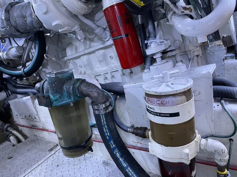 Slide: The Image of Engine room of 1987 Lien Hwa 47' Mark III Sundeck Yacht, showing filters and hoses. - 42