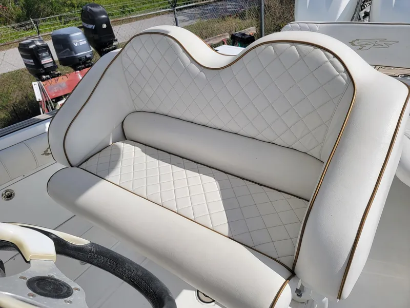 Slide: The Image of 2018 Glasstream 328SCX boat seat with diamond-stitched white upholstery and gold trim. - 10