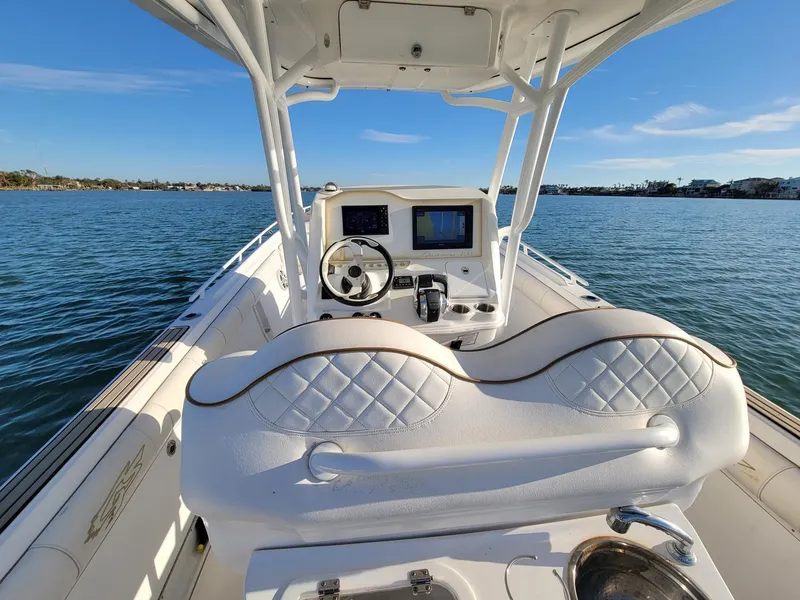 Slide: The Image of 2018 Glasstream 328SCX boat interior with steering wheel and navigation system on calm water. - 3