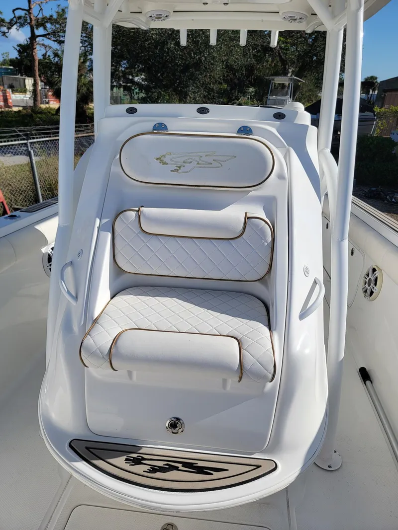Slide: The Image of 2018 Glasstream 328SCX boat seating with white quilted upholstery and logo detail. - 5