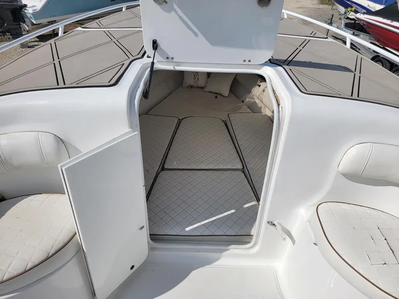 Slide: The Image of 2018 Glasstream 328SCX boat cabin interior with cushioned seating and open hatch. - 7
