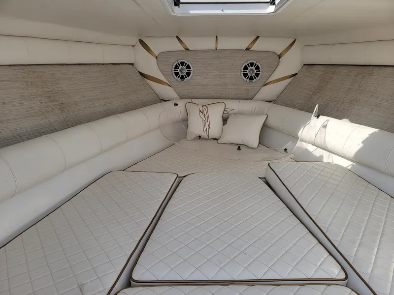 Slide: The Image of 2018 Glasstream 328SCX cabin interior with white quilted upholstery and decorative pillows. - 8