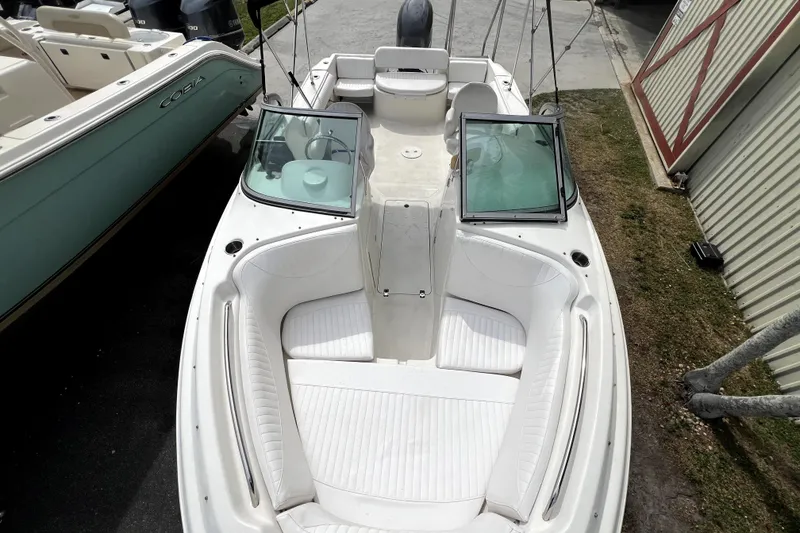 Slide: The Image of 2008 NauticStar 2000 DC Offshore boat with white seating and open windshield. - 10