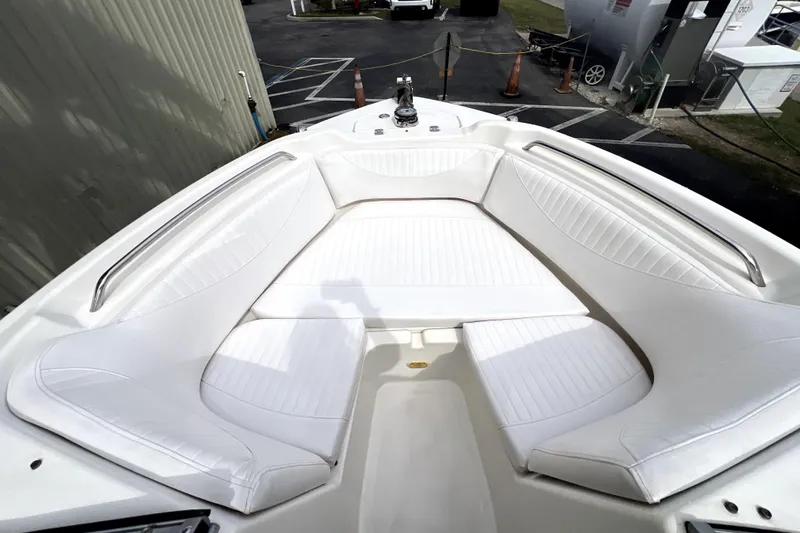 Slide: The Image of 2008 NauticStar 2000 DC Offshore boat with white cushioned seating area. - 11