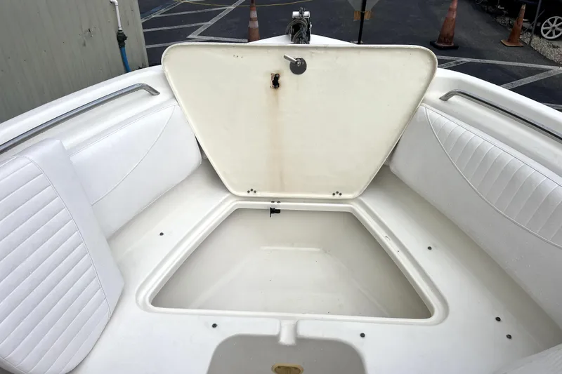 Slide: The Image of Open storage compartment on 2008 NauticStar 2000 DC Offshore boat, featuring white seating. - 12