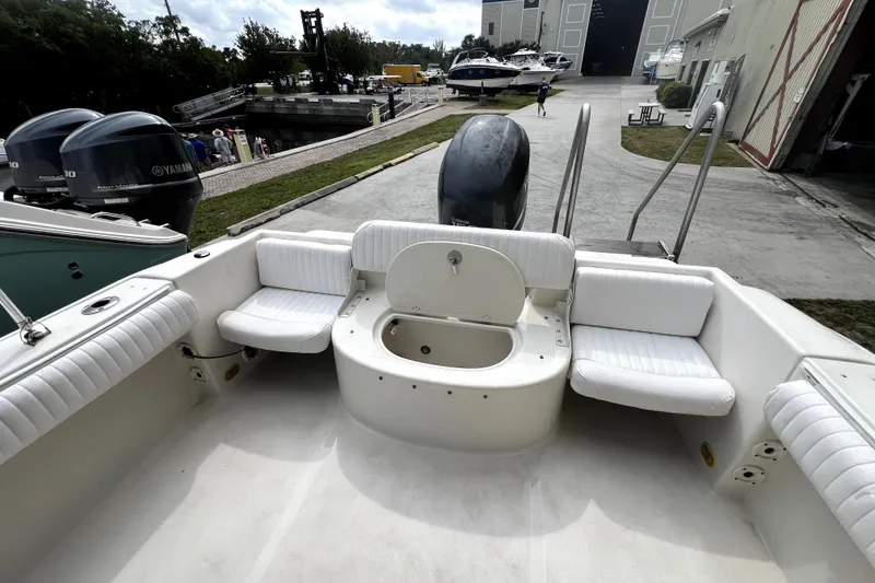 Slide: The Image of 2008 NauticStar 2000 DC Offshore boat interior with seating and engine view. - 14