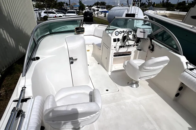 Slide: The Image of 2008 NauticStar 2000 DC Offshore boat interior with white seating and steering console. - 16