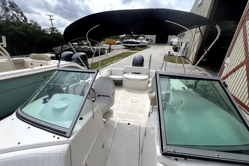 Slide: The Image of 2008 NauticStar 2000 DC Offshore boat with canopy, docked at marina. - 17