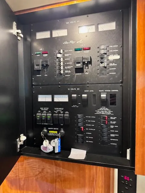 Slide: The Image of Electrical panel of a 2001 Sea Ray 410 Sundancer boat, featuring various switches and controls. - 12