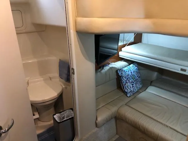 Slide: The Image of 2001 Sea Ray 410 Sundancer cabin interior with bathroom and seating area. - 13