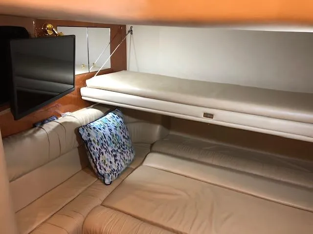Slide: The Image of Interior cabin of 2001 Sea Ray 410 Sundancer with beige seating and TV. - 14