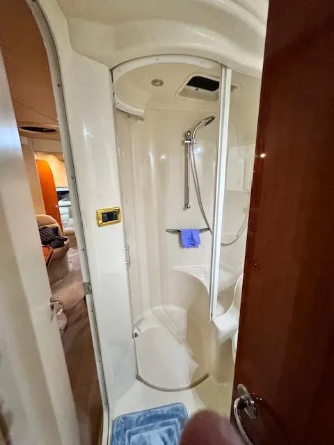 Slide: The Image of Shower area in 2001 Sea Ray 410 Sundancer yacht, featuring modern fixtures and compact design. - 16