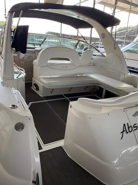 Slide: The Image of 2001 Sea Ray 410 Sundancer yacht interior with seating and table under canopy. - 19