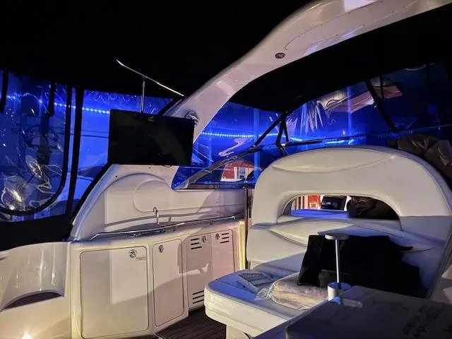 Slide: The Image of 2001 Sea Ray 410 Sundancer interior with blue LED lighting and modern amenities. - 21