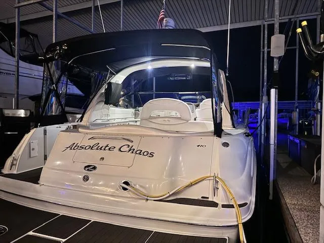 Slide: The Image of 2001 Sea Ray 410 Sundancer yacht docked at night, named "Absolute Chaos." - 22