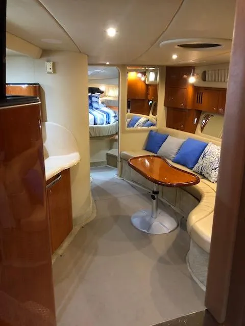 Slide: The Image of Interior of 2001 Sea Ray 410 Sundancer yacht with cozy seating and modern amenities. - 5