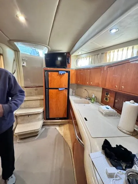 Slide: The Image of Interior of 2001 Sea Ray 410 Sundancer yacht with kitchen and stairs. - 8