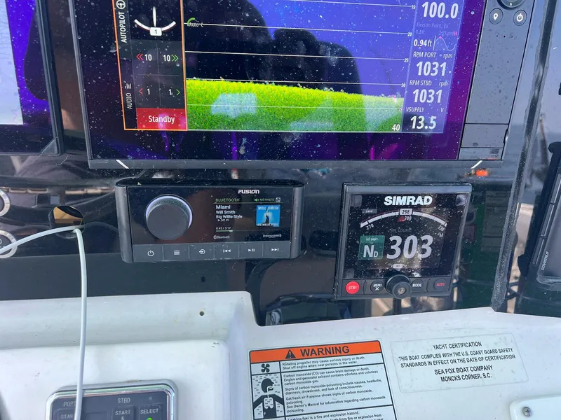 Slide: The Image of Dashboard of a 2015 Sea Fox 286 Commander with navigation and audio controls. - 10