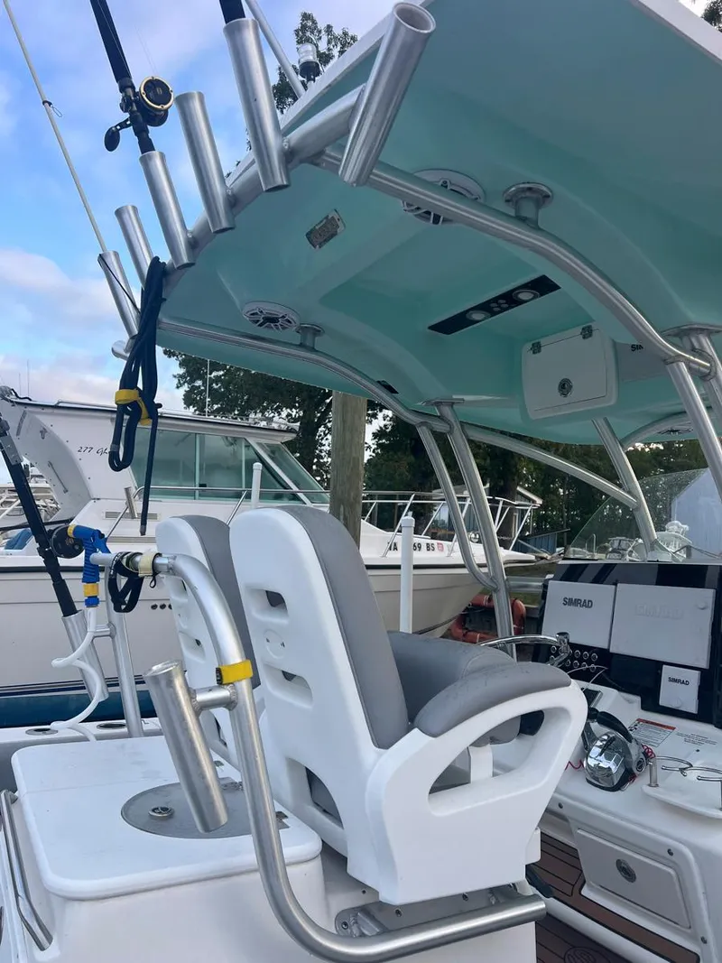 Slide: The Image of 2015 Sea Fox 286 Commander boat interior with fishing rod holders and seating. - 4