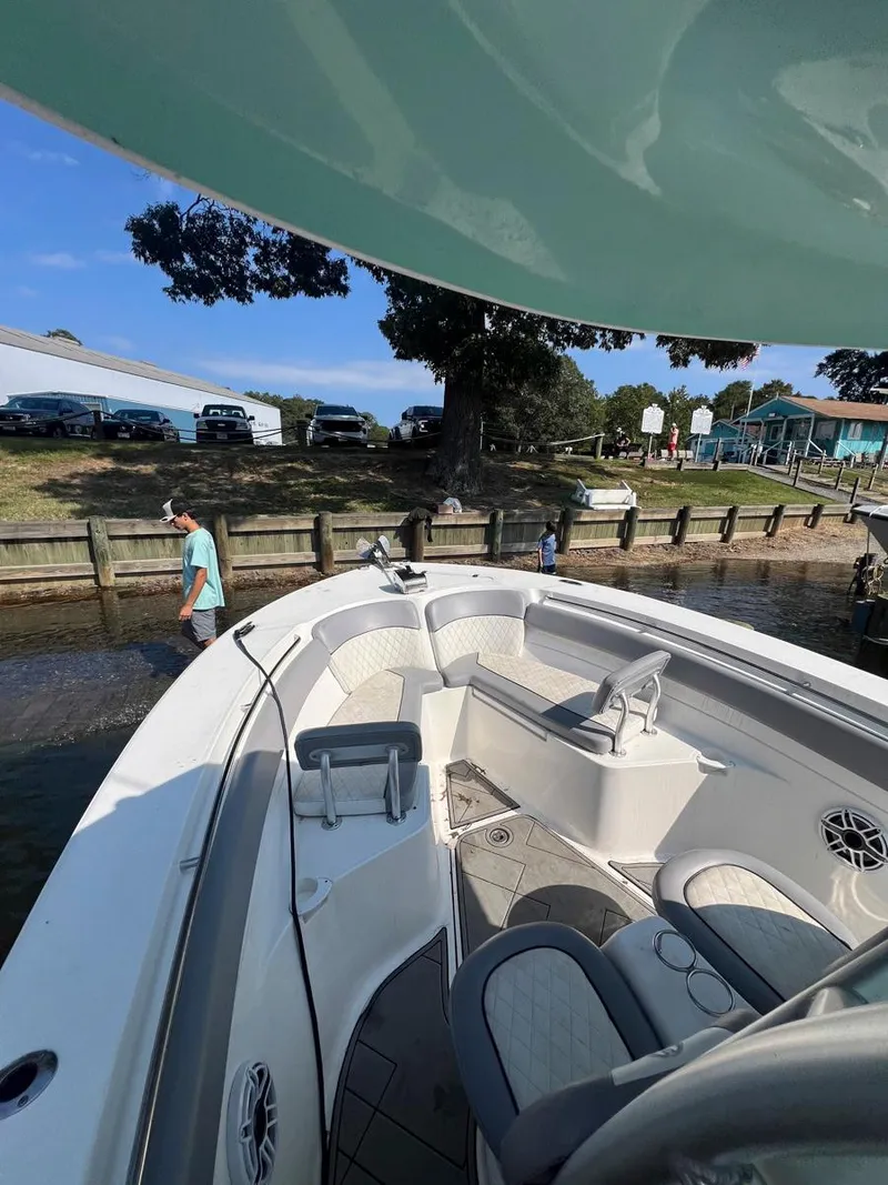Slide: The Image of 2015 Sea Fox 286 Commander boat docked near a waterfront with people walking nearby. - 5