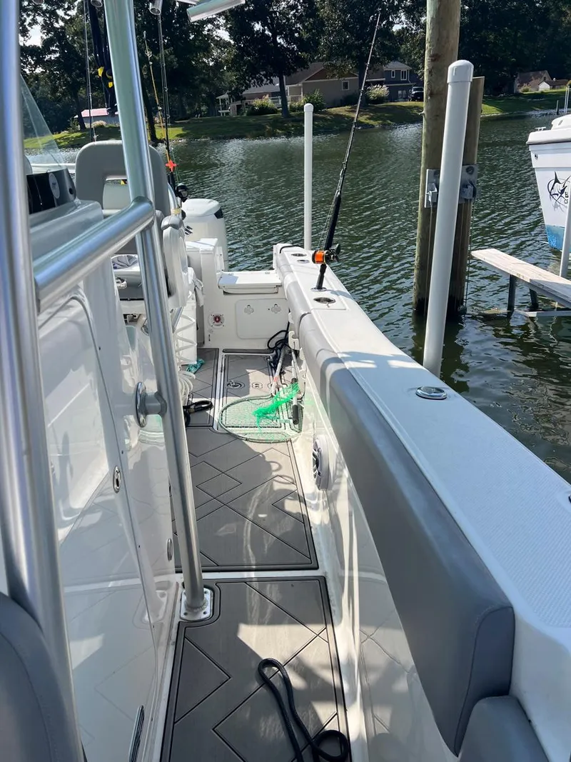 Slide: The Image of 2015 Sea Fox 286 Commander boat docked by a serene lake. - 6