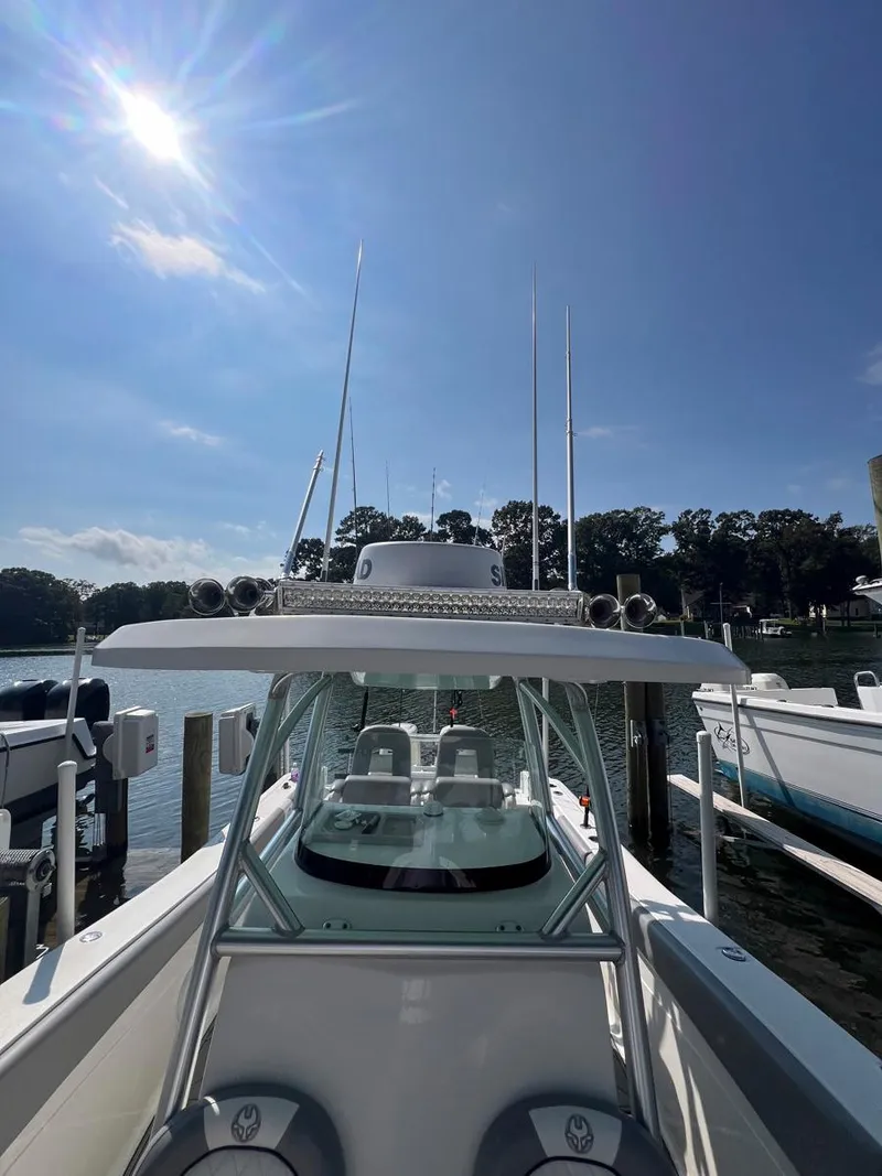 Slide: The Image of 2015 Sea Fox 286 Commander boat docked under a clear blue sky. - 8
