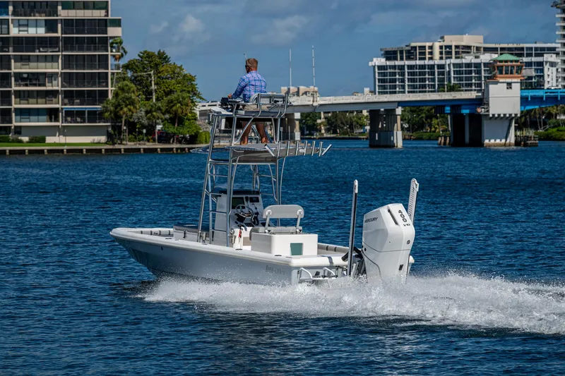 Slide: The Image of 2023 Lake & Bay Backwater boat cruising on a scenic waterway near urban buildings. - 10