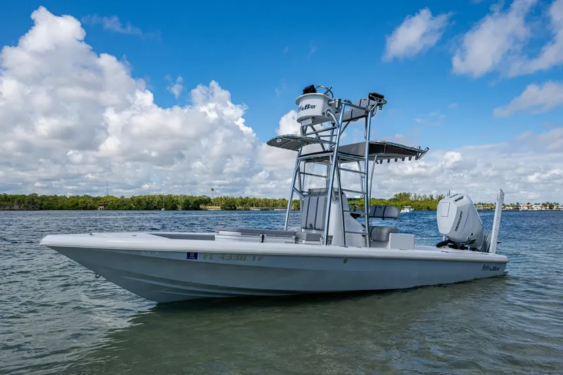 Slide: The Image of 2023 Lake & Bay Backwater boat on calm water under a blue sky. - 15