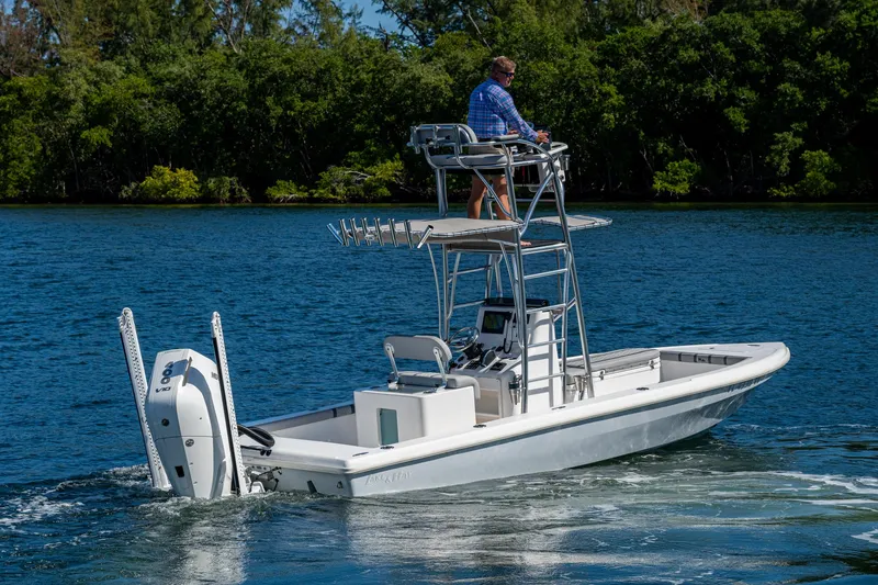 Slide: The Image of 2023 Lake & Bay Backwater boat cruising on a serene lake with lush greenery. - 17
