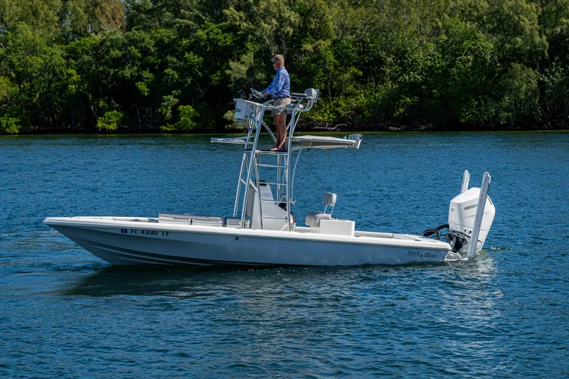 Slide: The Image of 2023 Lake & Bay Backwater boat on a lake with a person steering. - 24