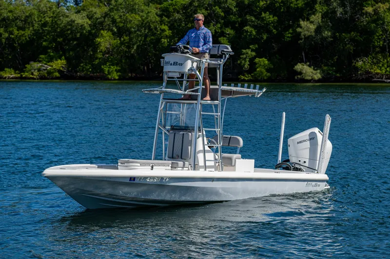 Slide: The Image of 2023 Lake & Bay Backwater boat on a lake with a person steering. - 26