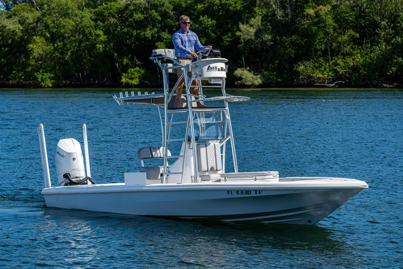 Slide: The Image of 2023 Lake & Bay Backwater boat on a lake with a person steering. - 31