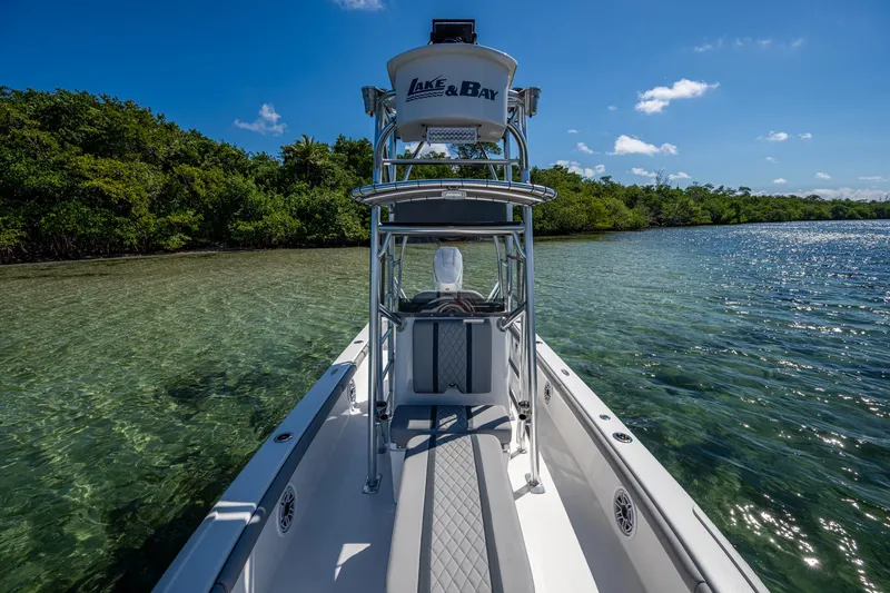 Slide: The Image of 2023 Lake & Bay Backwater boat on clear water near lush shoreline. - 39