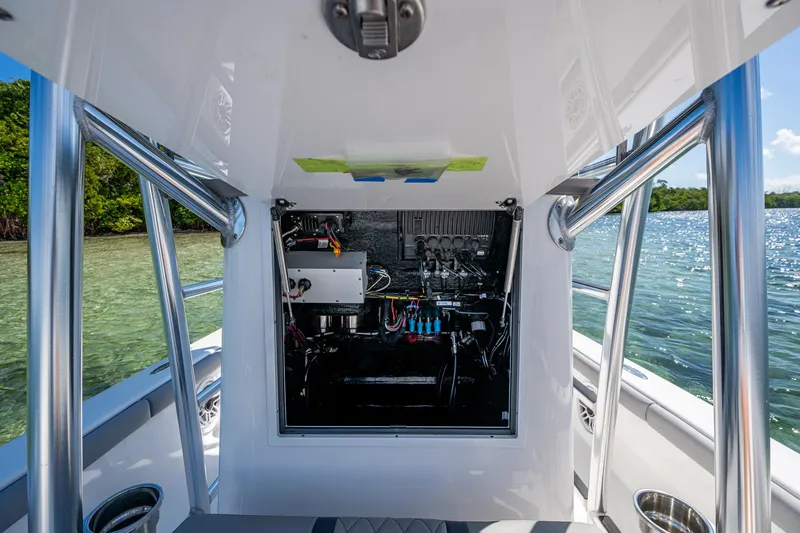 Slide: The Image of 2023 Lake & Bay Backwater boat interior with open console, showing wiring and equipment. - 43