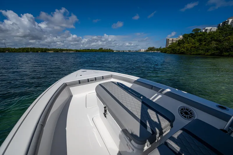 Slide: The Image of 2023 Lake & Bay Backwater boat on a scenic lake with clear skies. - 46