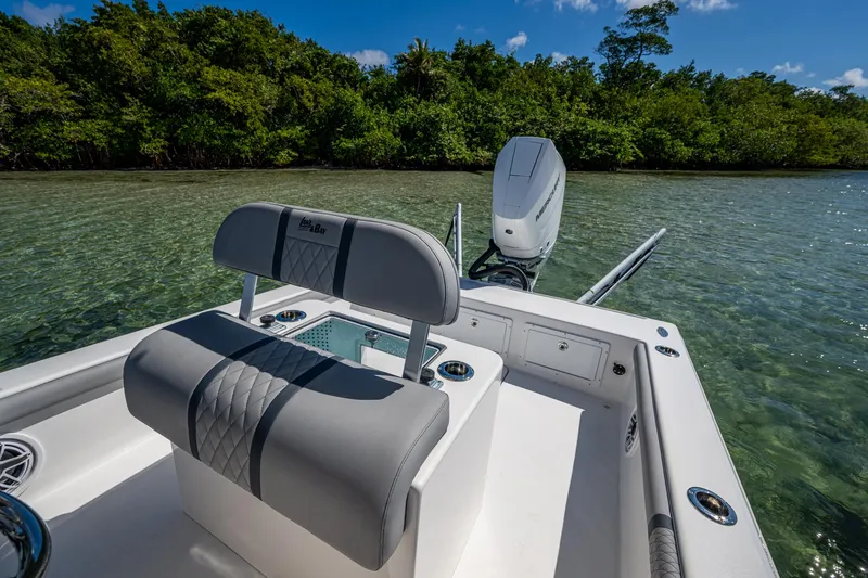 Slide: The Image of 2023 Lake & Bay Backwater boat on clear water near lush green shoreline. - 48