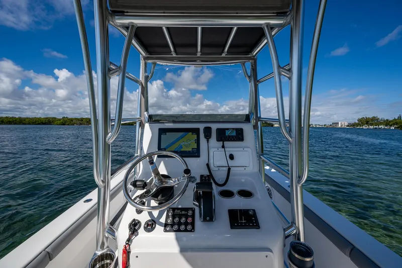 Slide: The Image of 2023 Lake & Bay Backwater boat console with steering wheel and navigation system on open water. - 49