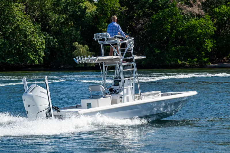 Slide: The Image of 2023 Lake & Bay Backwater boat cruising on a scenic waterway with lush greenery. - 5