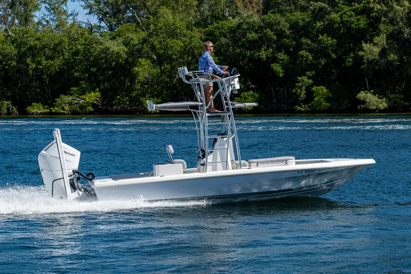 Slide: The Image of 2023 Lake & Bay Backwater boat cruising on a scenic waterway with lush greenery. - 6