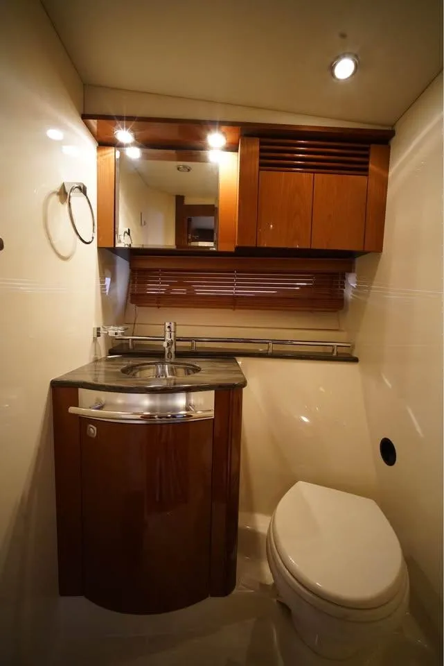 Slide: The Image of Luxurious bathroom in 2012 Sea Ray 500 Sundancer yacht with modern fixtures and wood accents. - 10