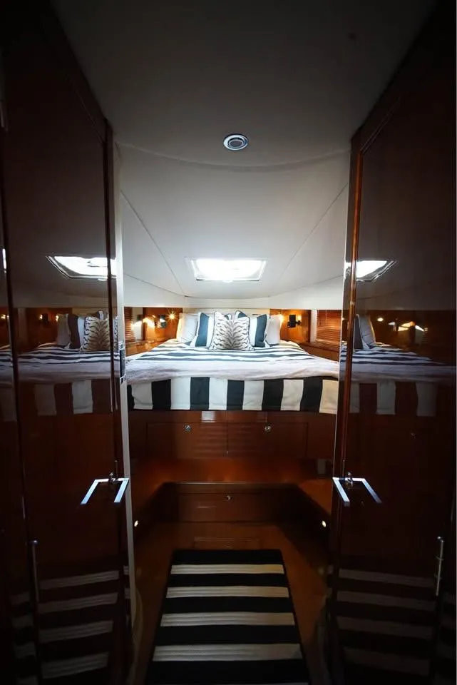 Slide: The Image of Luxurious interior of 2012 Sea Ray 500 Sundancer yacht with elegant bedding and lighting. - 11