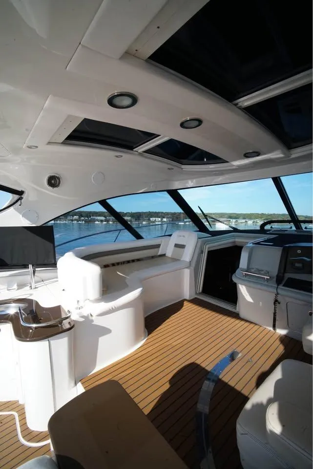 Slide: The Image of 2012 Sea Ray 500 Sundancer yacht interior with modern design and panoramic windows. - 14